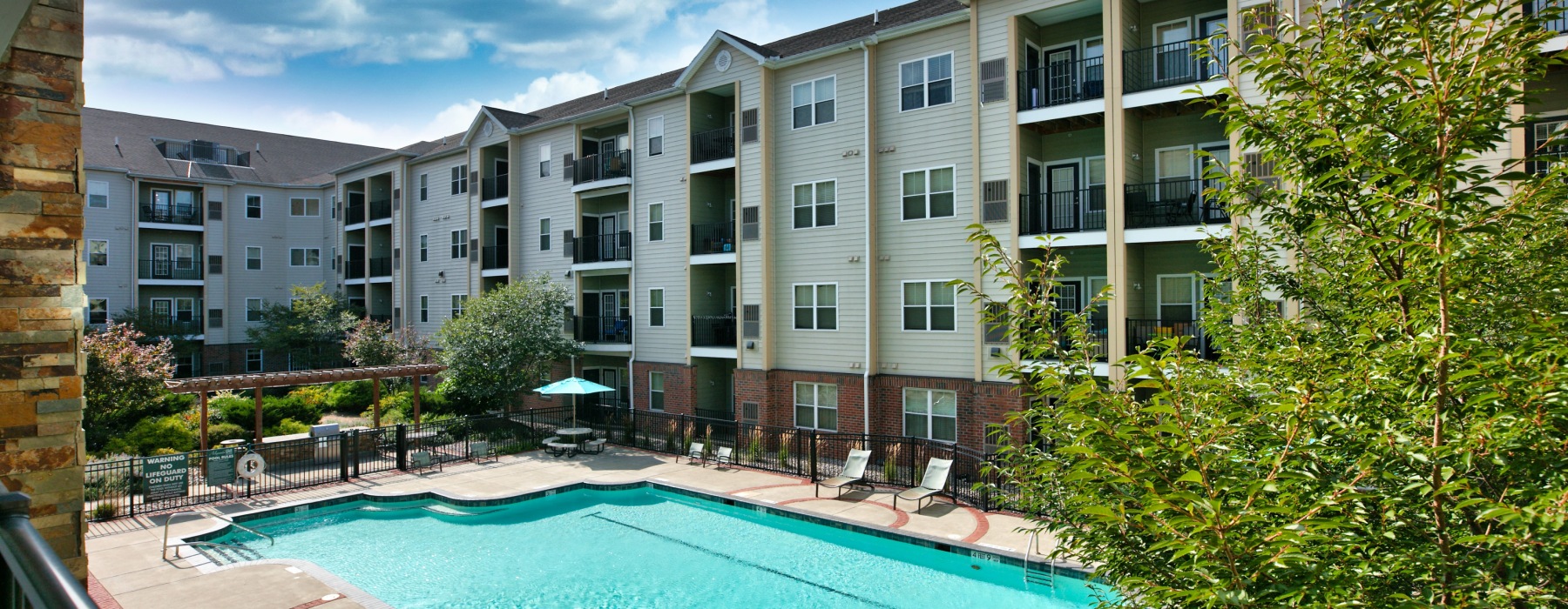 Resort-style swimming pool with lounge seating